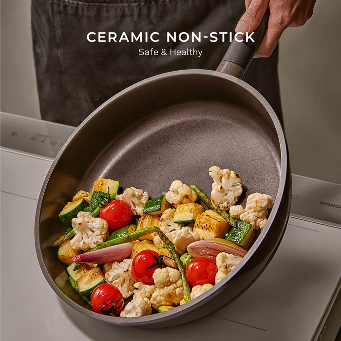Cuckoo 11-inch Kyndell ceramic non-stick frying pan filled with sautéed vegetables, emphasizing safe and healthy cooking. (CFP-B2810HGB)