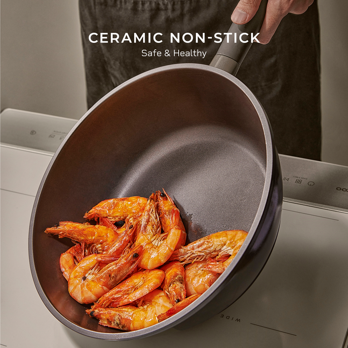 Cuckoo ceramic non-stick wok pan containing cooked shrimp, highlighting the safe and healthy cooking surface. (COP-B2810HGB)
