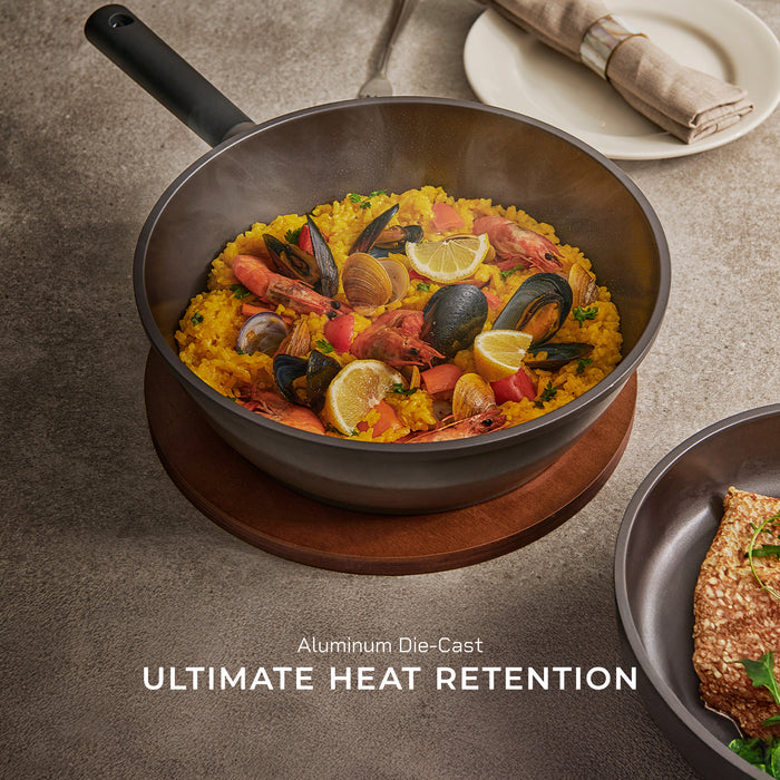 Aluminum die-cast pan featuring excellent heat retention, filled with a freshly cooked seafood paella. (COP-B2810HGB)