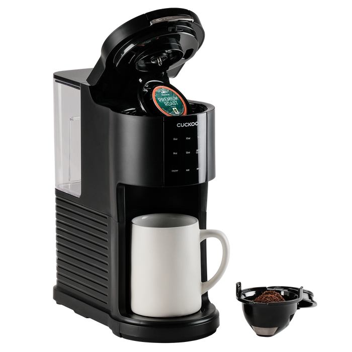 Black CUCKOO K-Cup single-serve coffee maker with its lid open, a white mug in place, and a reusable pods alongside. (CCM-AK011B)