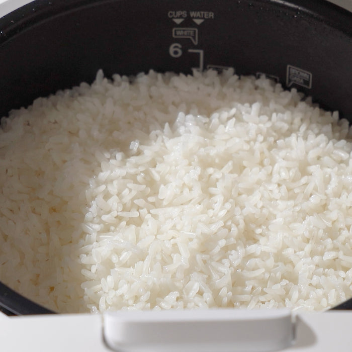 Close-up of freshly cooked white rice inside a Cuckoo rice cooker's inner pot. (CR-0661F)