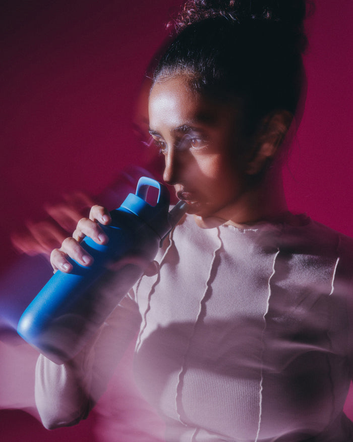 All-Purpose Thermo Straw Lid bottle held by person.