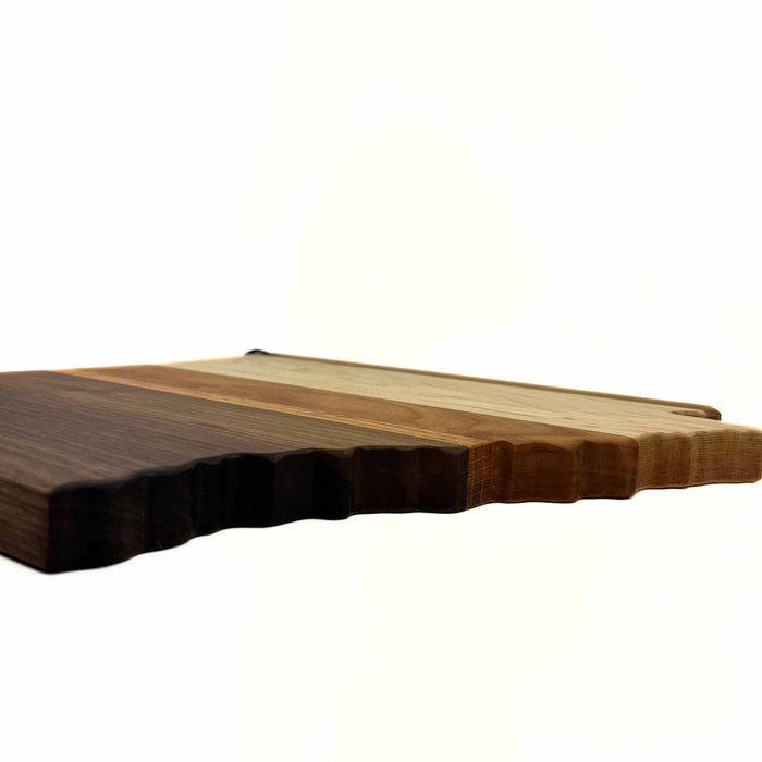 Side view of Arkansas-shaped cutting board with mixed wood types