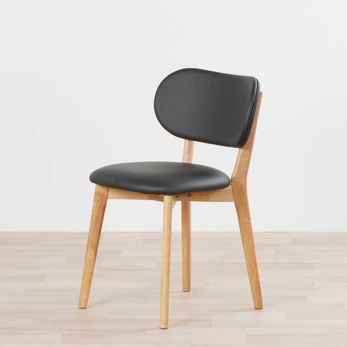 A Briar dining chair with an oak frame and black upholstery.