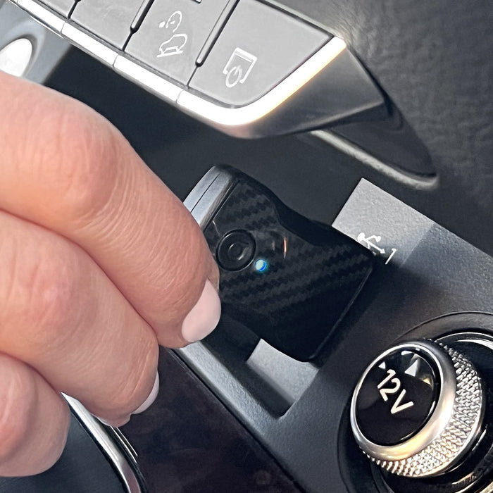 Wireless car adapter button with small LED indicator on car center console