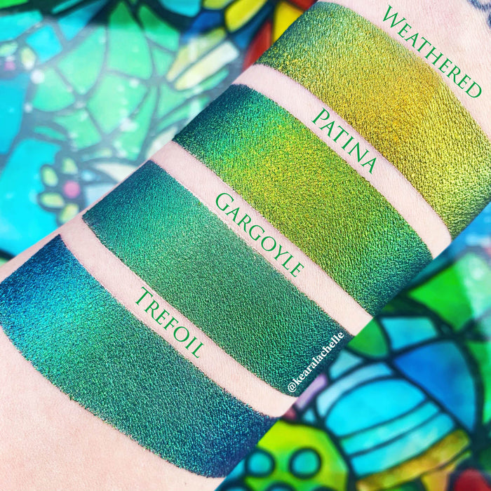 Top angled arm swatches on fair skin tone of Gargoyle Jewelled Multichrome Eyeshadow shifts compared to Weathered, Patina, Trefoil