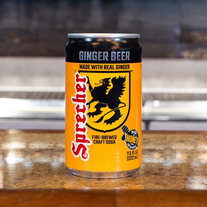 Sprecher ginger beer can on a wooden surface with a blurred background