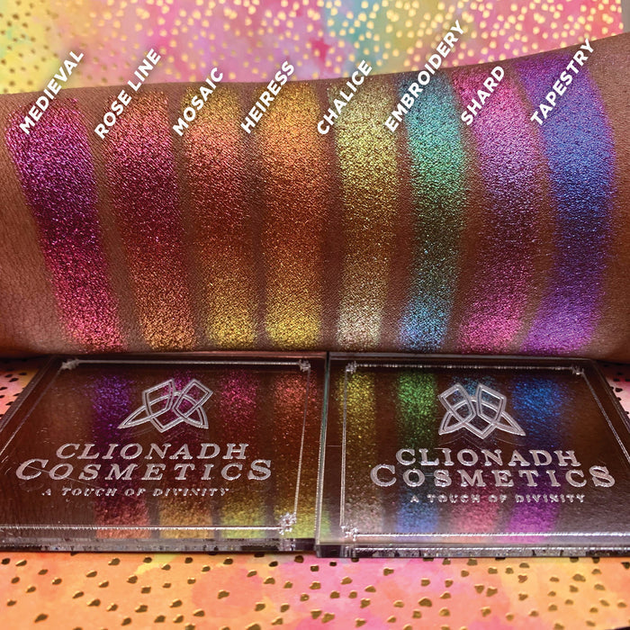 Straight angled arm swatches on deep skin tone of Heiress Hybrid Multichrome Eyeshadow shifts compared to Medieval, Rose Line, Mosaic, Chalice, Embroidery, Shard, Tapestry