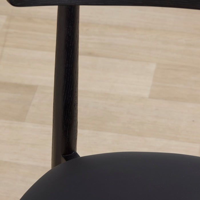 close up of the henry dining chair seat black oak and Pu