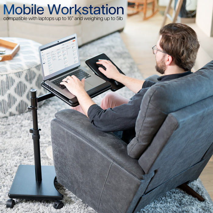 Person using a laptop on a portable desk in a living room setting