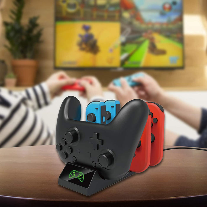 The dock is placed on the table and is charging one controller and two pairs of Joycons.