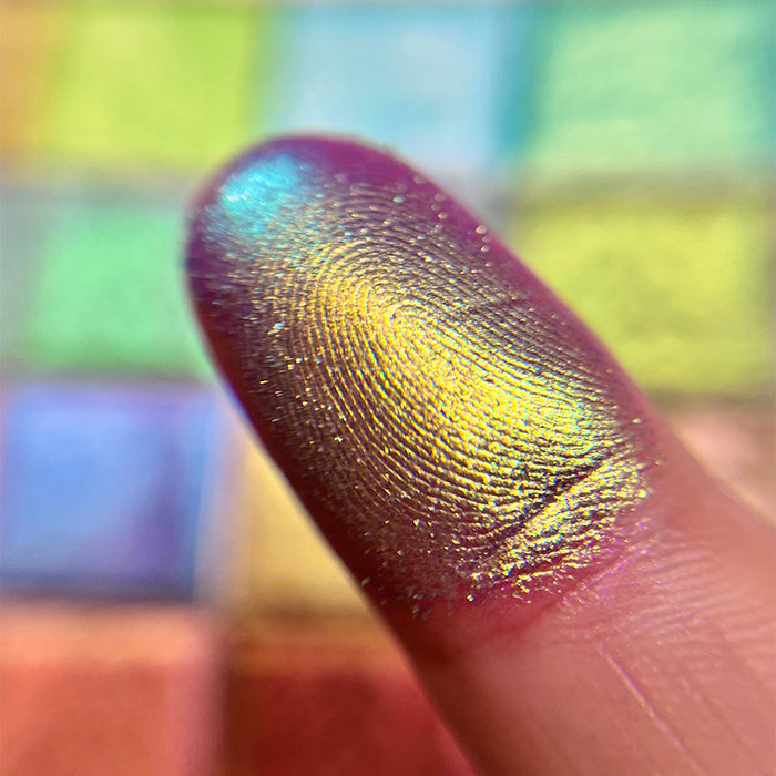 Close up finger swatch on fair skin tone of Niello Electric Multichrome Pigment