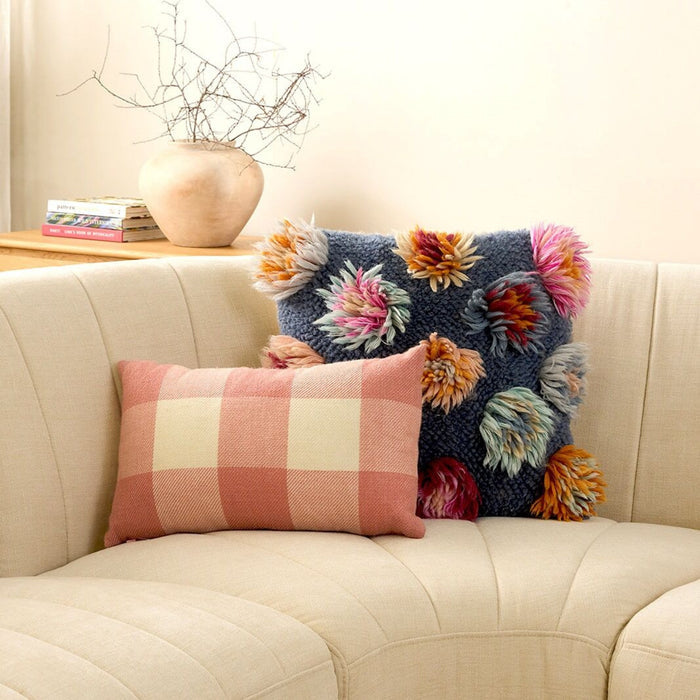 Noor 50x50cm Cushion - Multi, blue textured cushion with multicoloured tufted floral details, styled on a cream sofa.