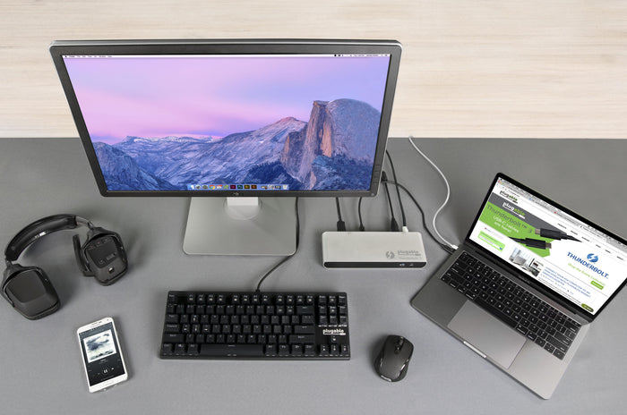 Plugable TBT3-UD1-83 Thunderbolt 3 dock connected to a laptop, monitor, keyboard, mouse, and headphones on a desk.