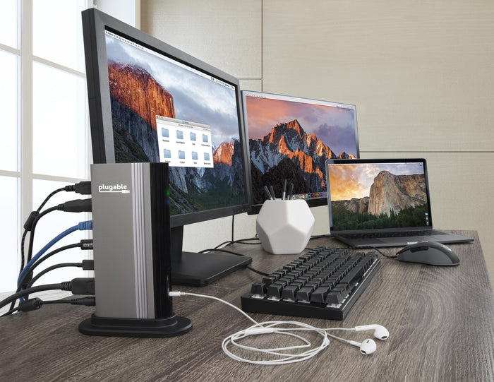 Plugable TBT3-UDV dock connected to two monitors, a laptop, keyboard, mouse, and headphones on a desk.