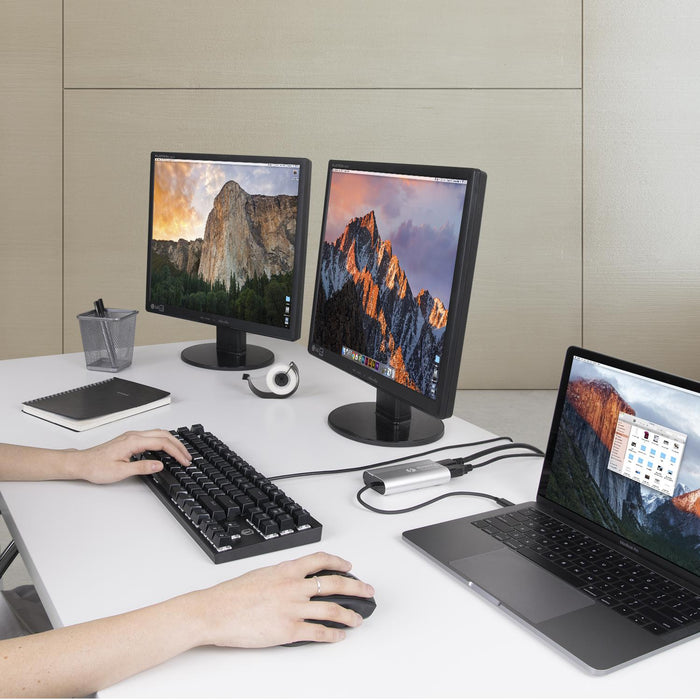 Plugable TBT3-HDMI2X-83 Thunderbolt 3 adapter connecting a laptop to two external monitors.