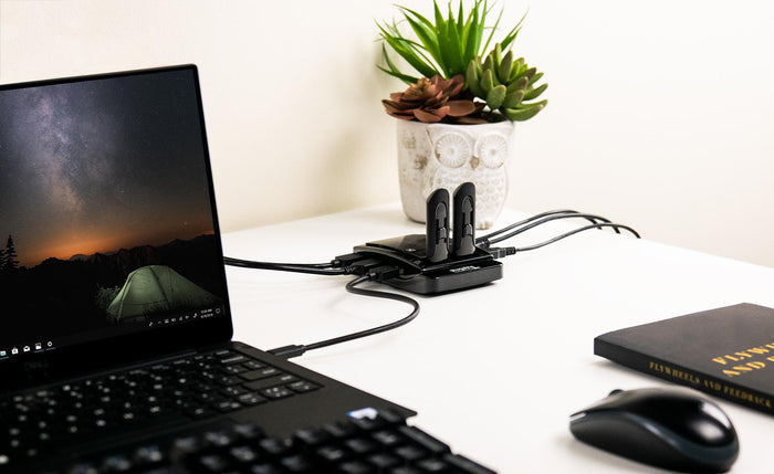 Plugable USB 2.0 7-Port Hub connected to a laptop with multiple USB devices plugged into the hub ports.