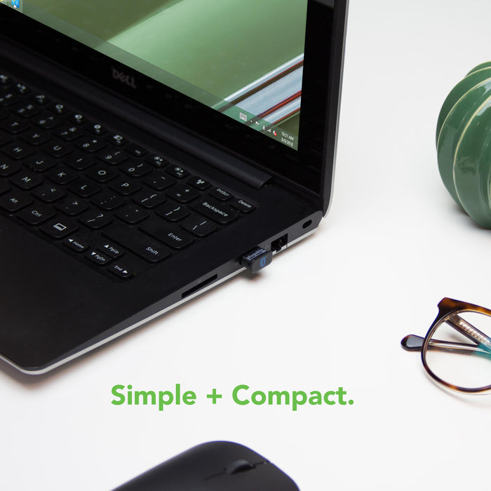 Plugable USB-BT4LE Bluetooth 4.0 adapter plugged into a laptop USB port with the text Simple + Compact.