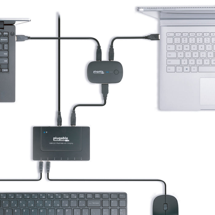 USB2-SWITCH2 connecting two laptops to a Plugable USB 2.0 7-Port Hub with Charging for shared keyboard and mouse.