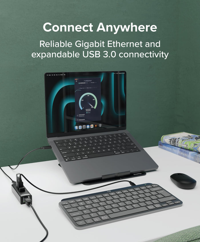 Plugable USB3-HUB3ME 3-port USB 3.0 hub with Gigabit Ethernet connected to a laptop showing 1000 Mbps speed test.