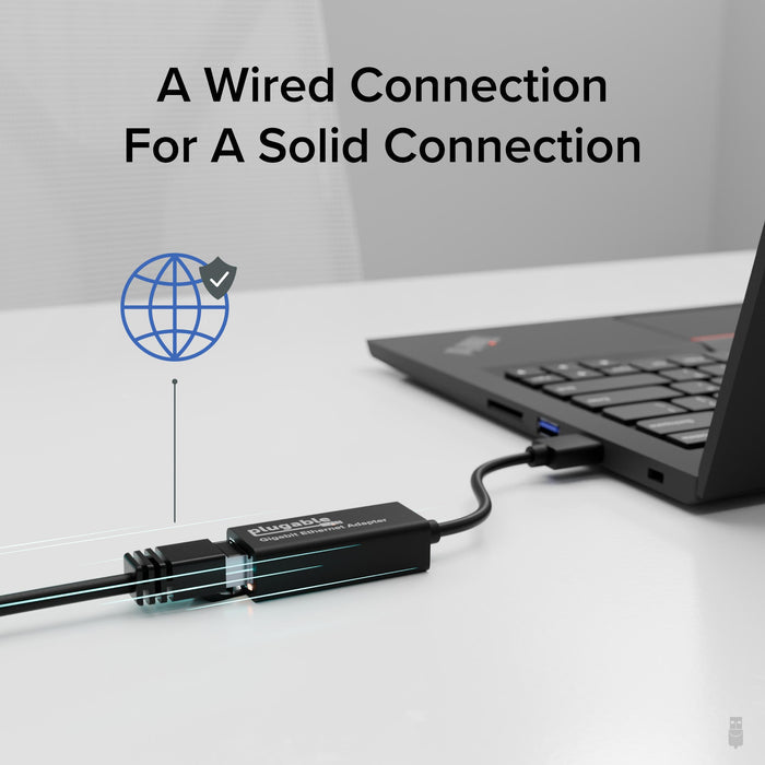 Plugable Gigabit Ethernet Adapter connected to a laptop USB port, providing a wired network connection.
