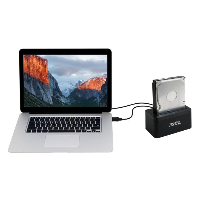 Plugable USBC-SATA-V hard drive dock connected to a laptop via USB cable with a 3.5-inch SATA hard drive inserted.