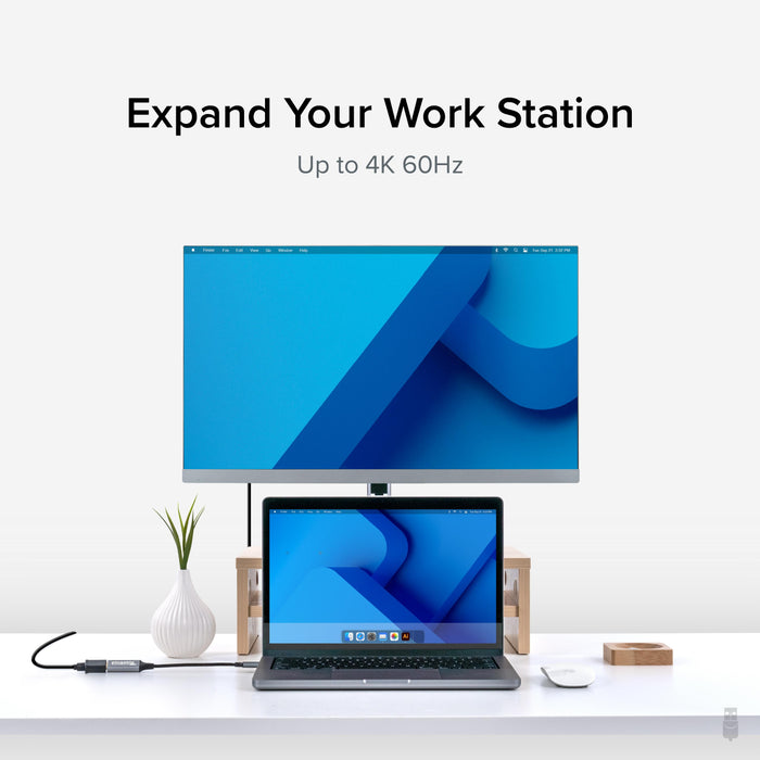 Plugable USBC-HDMI adapter connecting a laptop to an external monitor, supporting resolutions up to 4K at 60Hz.