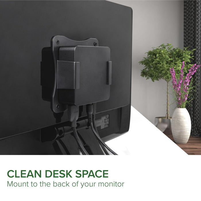 Plugable UD-CAM dock mounted to the back of a monitor, showing HDMI and cable connections.