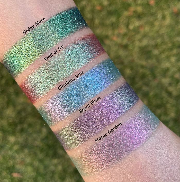 Top angled arm swatches on fair skin tone of Royal Plum Earth Vibrant Multichrome Eyeshadow shifts compared to Hedge Maze, Wall of Ivy, Climbing Vine and Statue Garden
