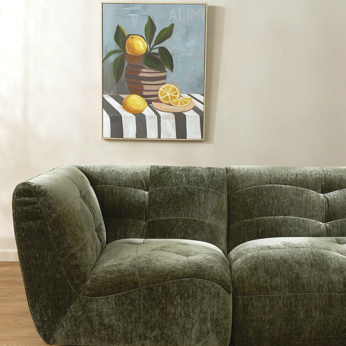 Still Life with Lemons Artwork, framed lemon still life wall art above a green velvet sofa.