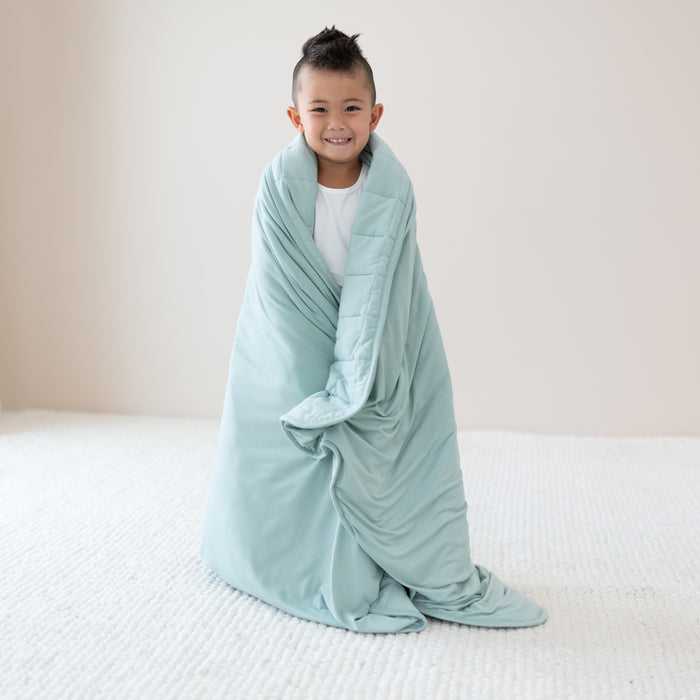 Toddler wrapped in Youth Blanket in Sage 2.5